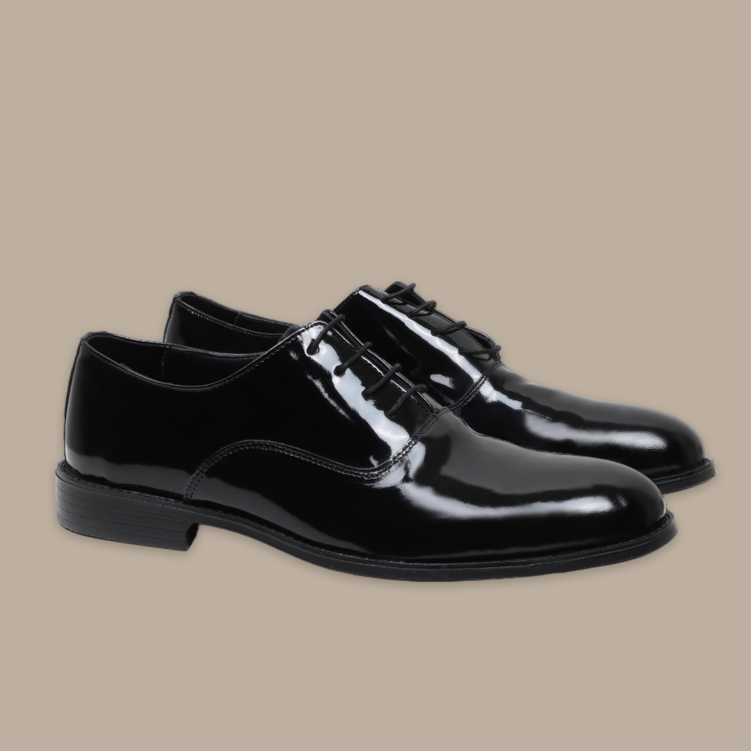 Black patent leather tuxedo shoes with sleek, shiny finish and lace-up design.
