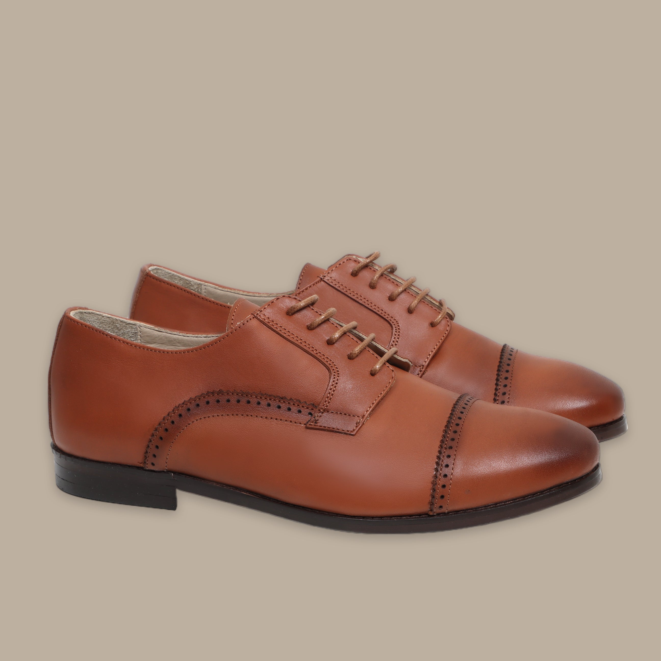 Brown leather Oxford shoes with brogue detailing and black soles, lace-up style.