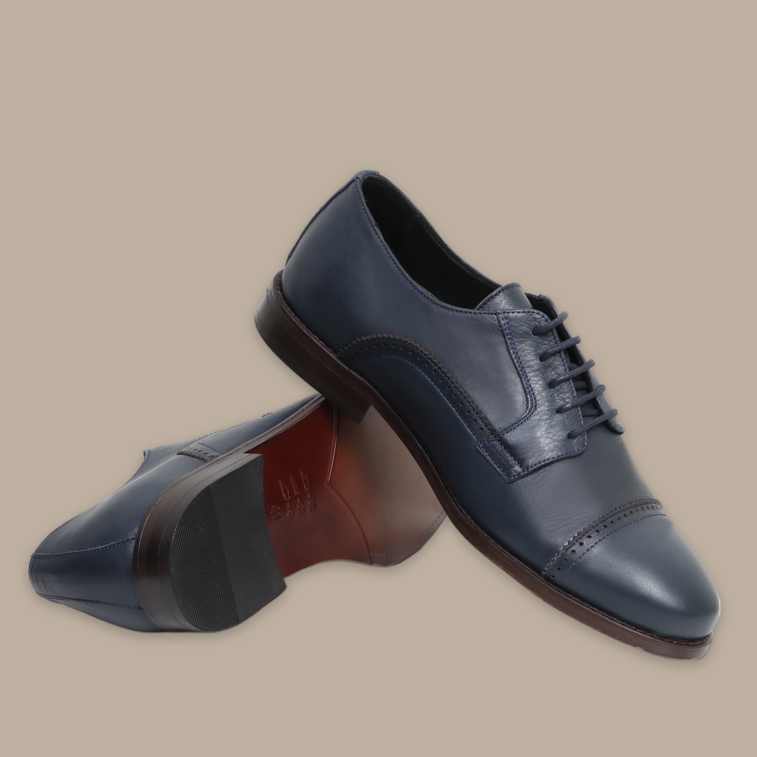 Navy leather Oxford shoes with cap toe and brown sole, lace-up design.
