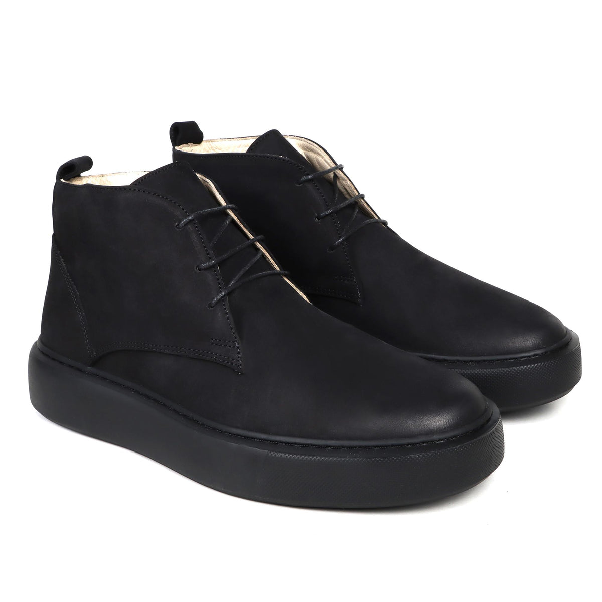 Black nubuck half boots with minimalist lace-up design and thick rubber sole.