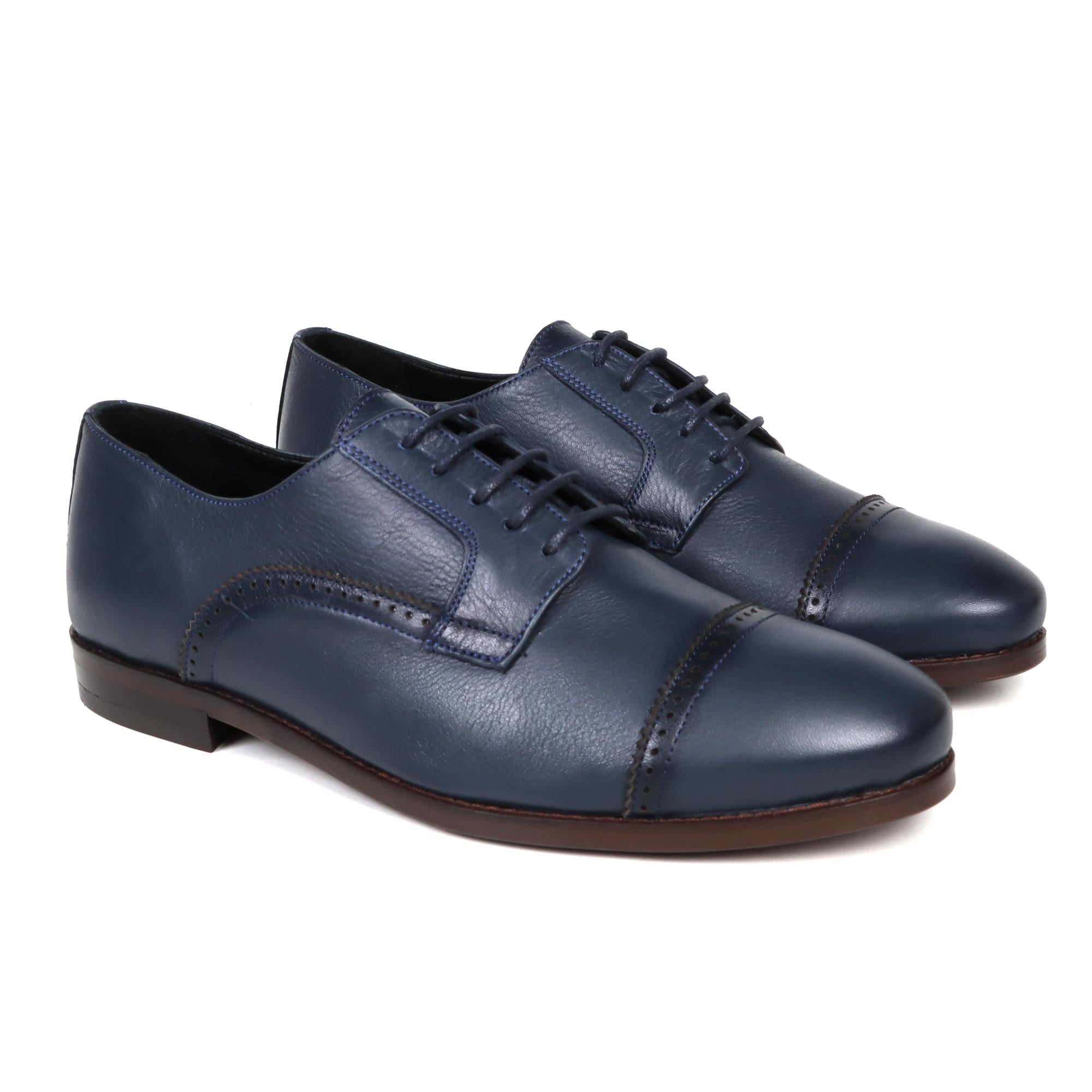 Navy leather Oxford shoes with cap toe and closed lacing, brown sole.