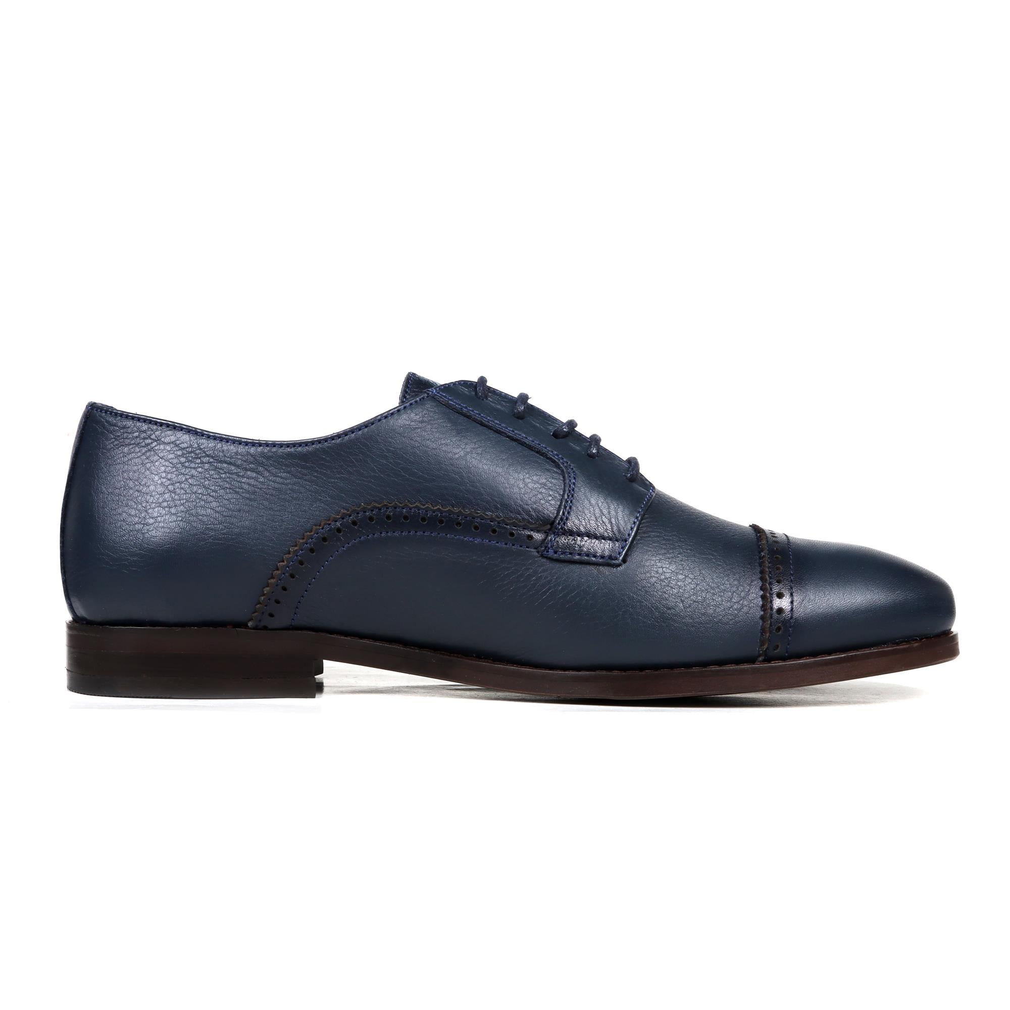 Navy leather Oxford shoe with cap toe and closed lacing on dark brown sole.