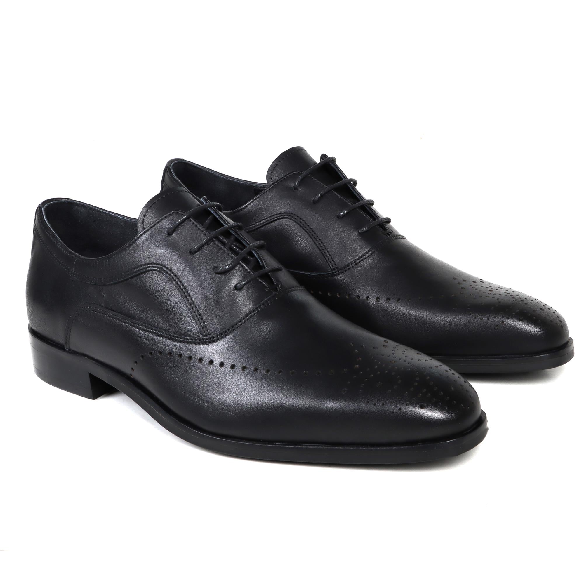 Black leather classic English lace-up shoes with brogue detailing and low heels.