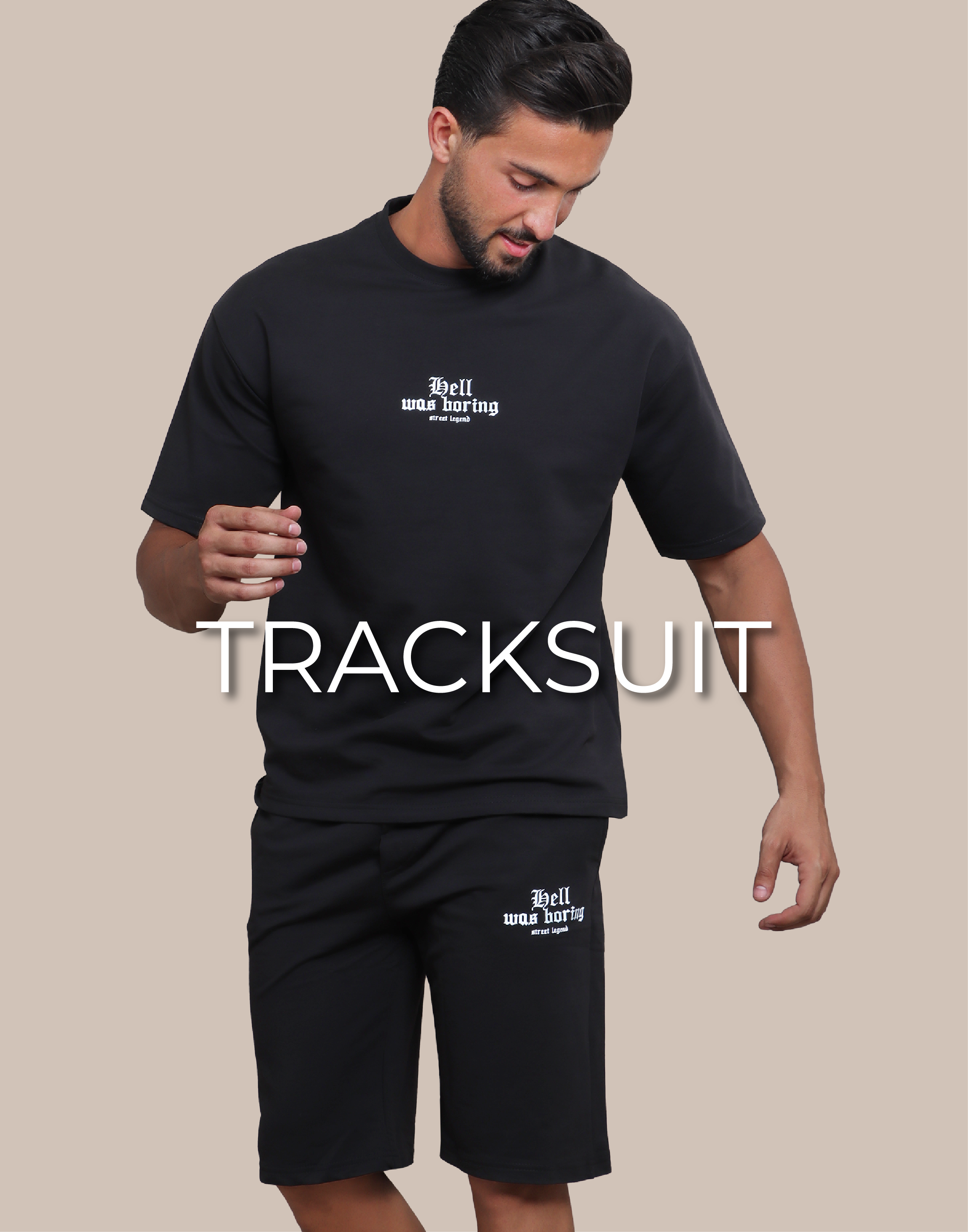 A Standing model is wearing a black tracksuit and is written on the image tracksuit