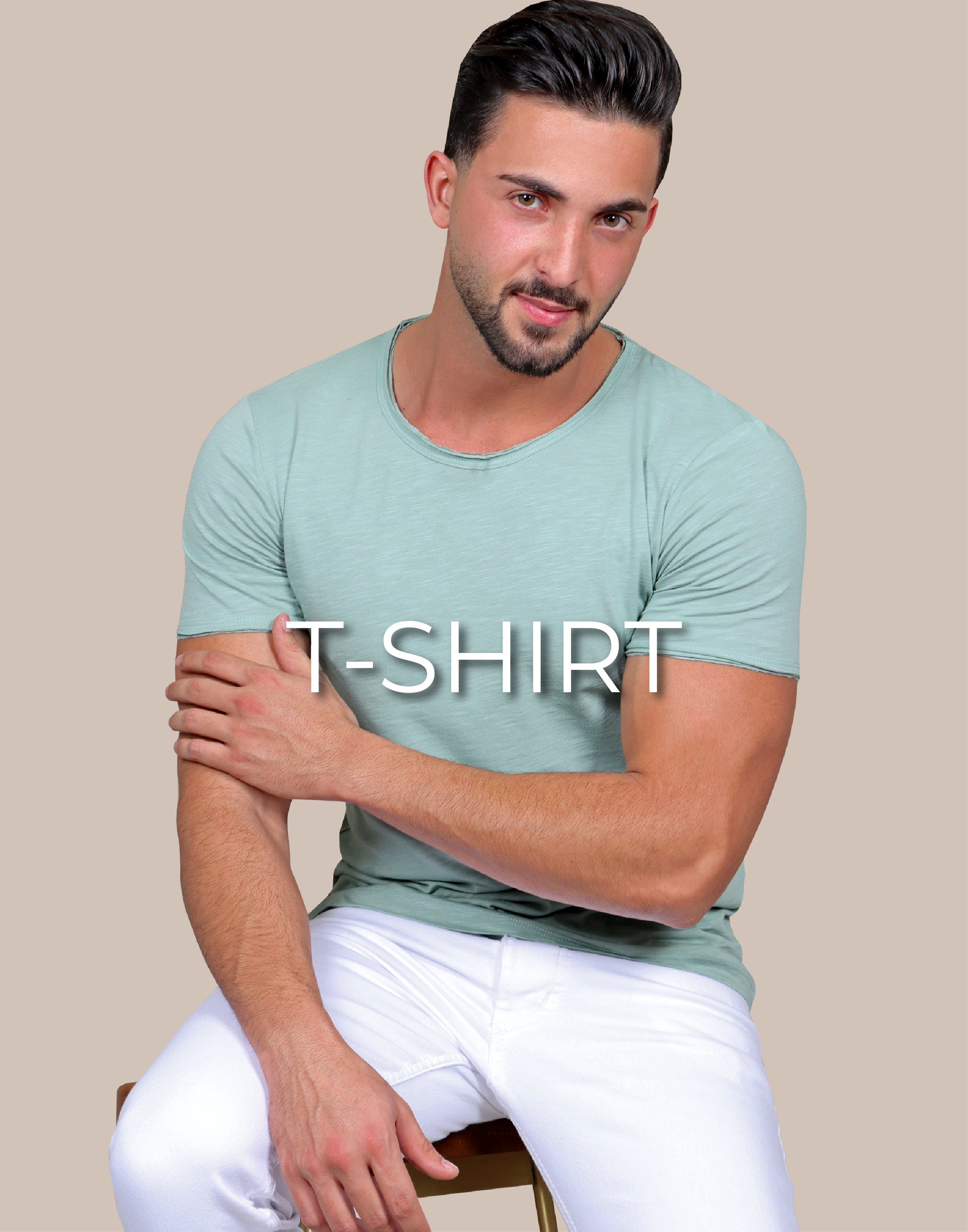 Model sitting on a chair and is wearing a t-shirt light green and a white pant, written on the image t-shirt